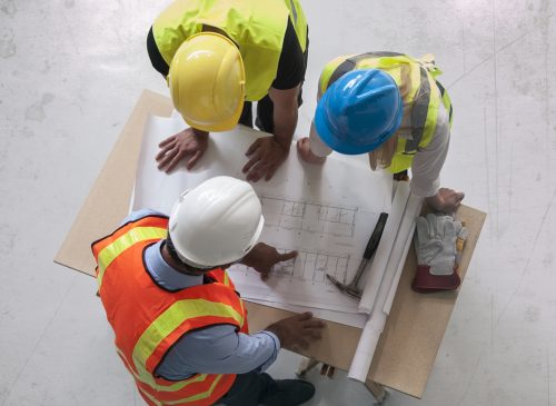 Engineers looking at blueprints